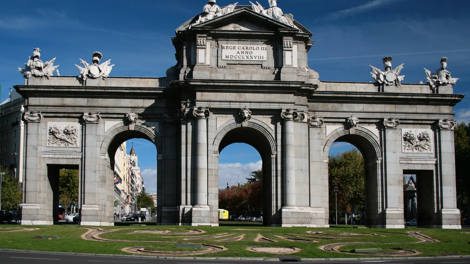 Puerta de Alcala Madrid arch viewed from Retiro Park area ideal for car rental sightseeing